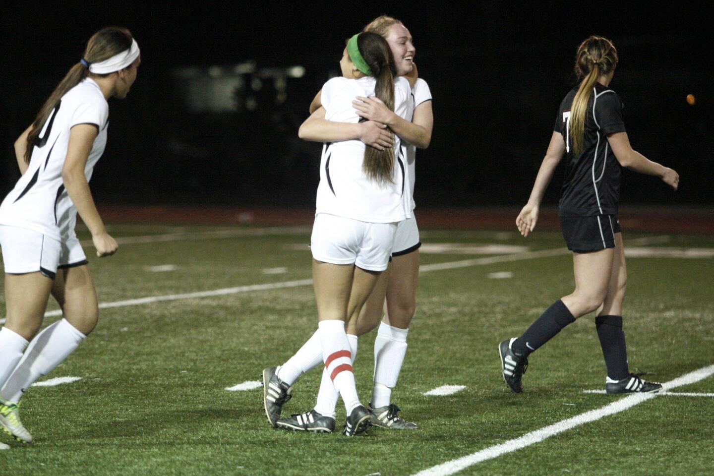 FSHA's Hailey James, top center, embraces Savannah Viola after making a point during a game against Harvard-Westlake at at St. Francis High School in La Canada on Friday, February 1, 2013.