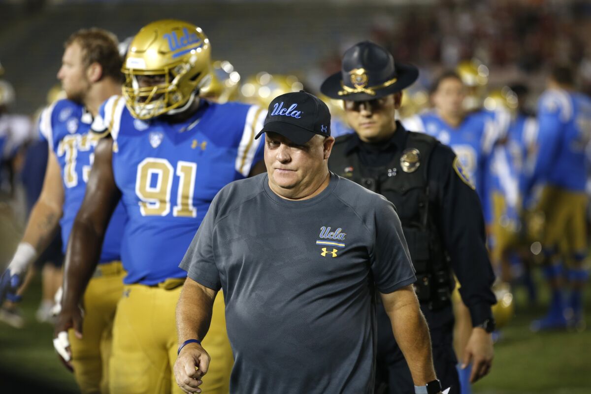 UCLA coach Chip Kelly walks off the field after losing to Oklahoma on Saturday.