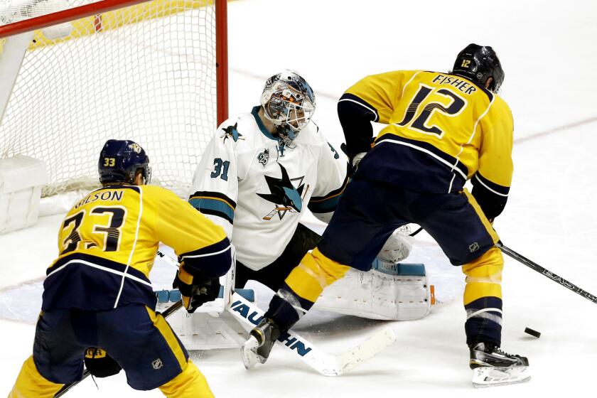 Predators forward Mike Fisher (12) prepares to score the winning goal against Sharks goalie Martin Jones (31) during the third overtime Thursday night.