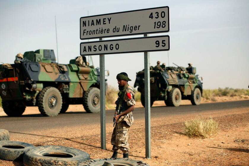 FILE - This Feb. 6, 2013, file photo shows French armoured vehicles heading towards the Niger border before making a left turn north in Gao, northern Mali. American and French forces have spent years providing training and support to the militaries of Mali, Niger and other vulnerable countries in this corner of Africa where Islamic extremism has become entrenched over the past decade.(AP Photo/Jerome Delay, File)