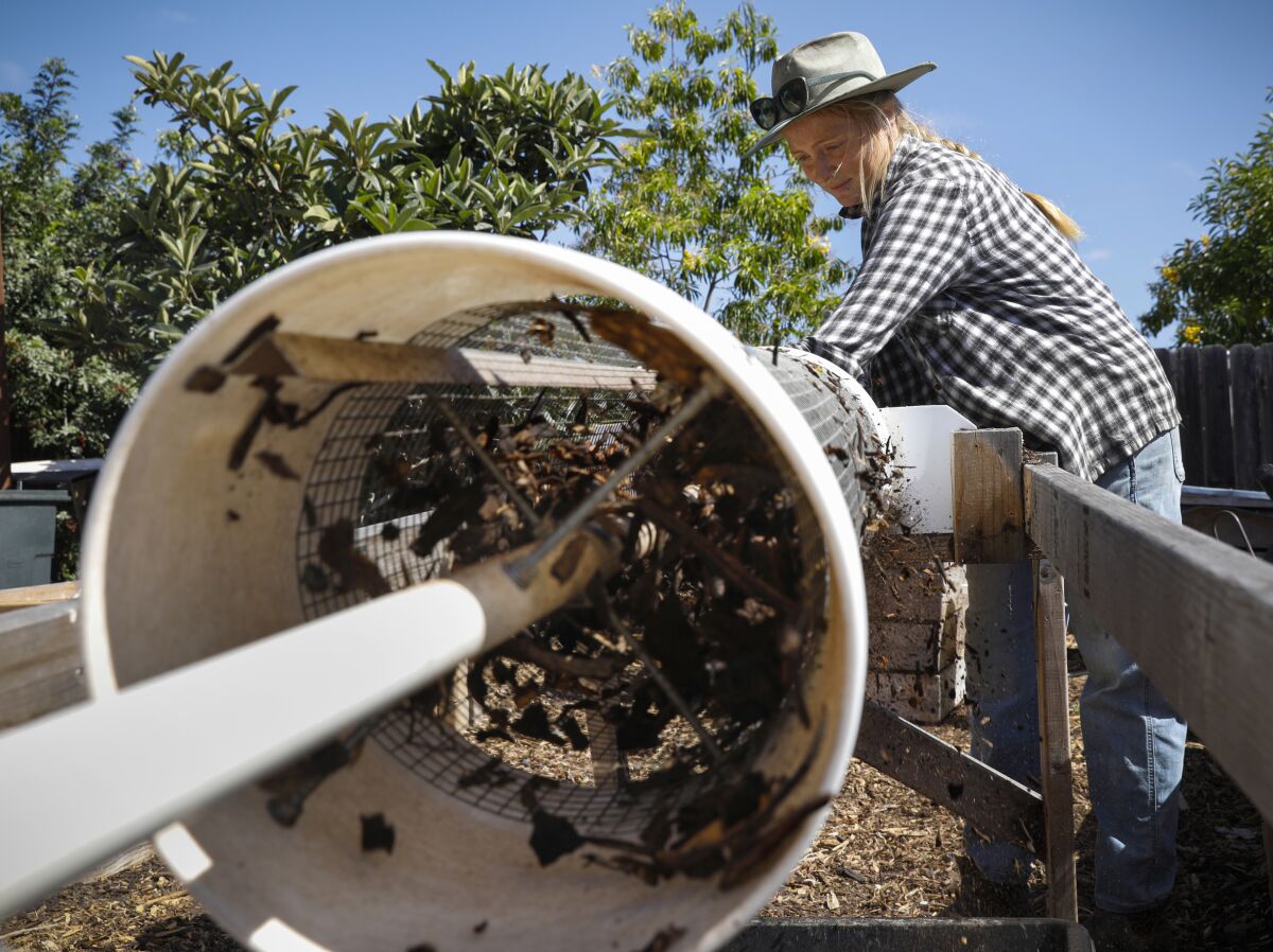 Food2Soil’s Alyssa Brodsky uses a trommel sifter to remove larger pieces of mulch from compost.