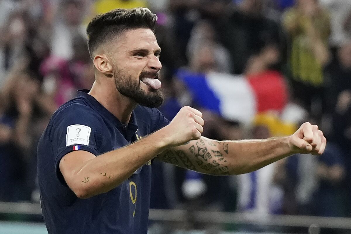 France's Olivier Giroud celebrates after Kylian Mbappe scored their side's second goal during the World Cup round of 16 soccer match between France and Poland, at the Al Thumama Stadium in Doha, Qatar, Sunday, Dec. 4, 2022. (AP Photo/Ricardo Mazalan)