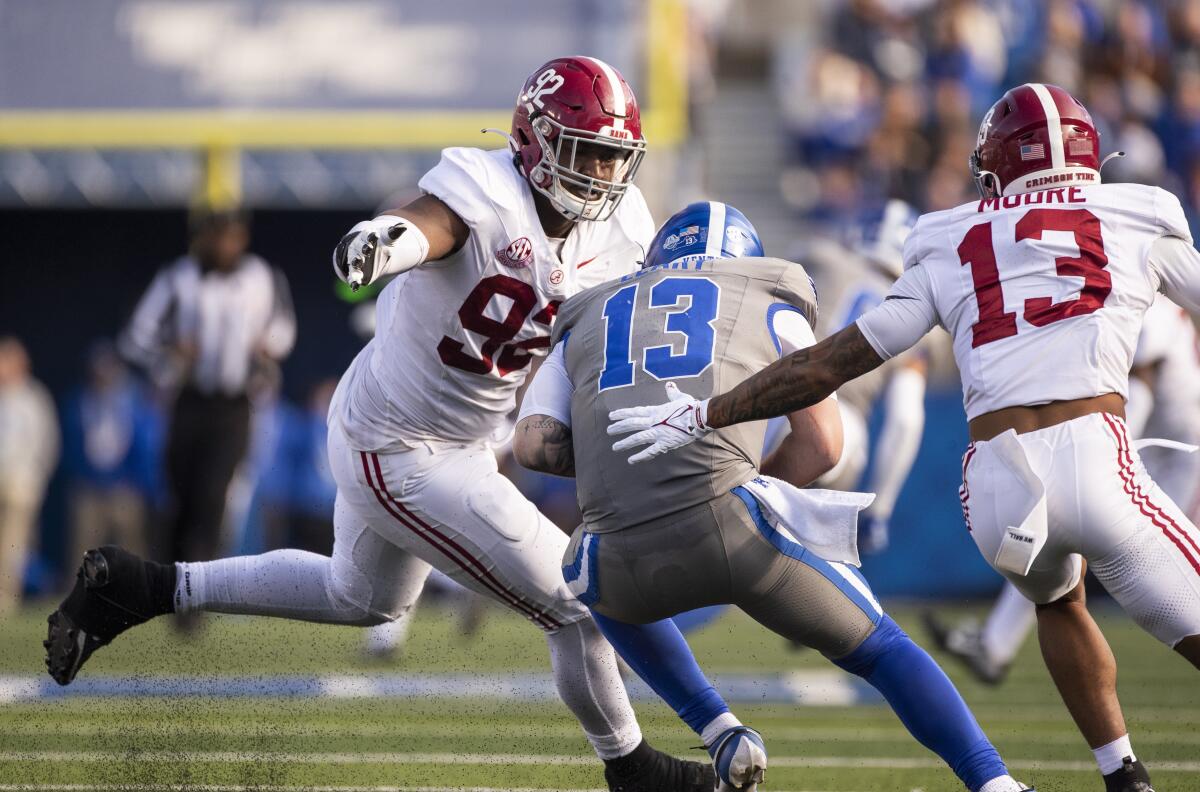 Alabama defensive lineman Justin Eboigbe attempts to tackle Kentucky quarterback Devin Leary 