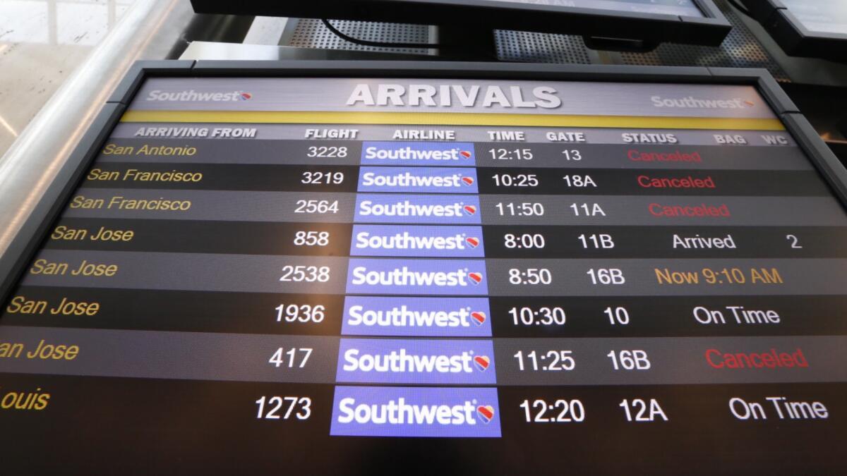 The arrivals board at Southwest Airlines Terminal 1 at LAX shows canceled and delayed flights Thursday morning.