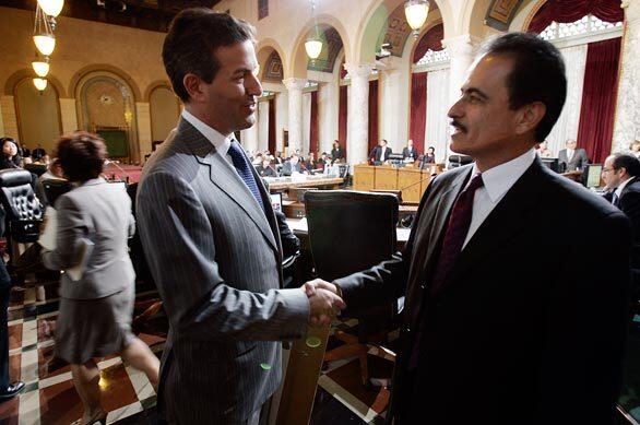 Wayne Pacelle, left, chief executive of the Humane Society of the United States, speaks with Los Angeles City Councilman Richard Alarcón at City Hall after passage of a law requiring that all pet owners in the city have their cats and dogs spayed or neutered.