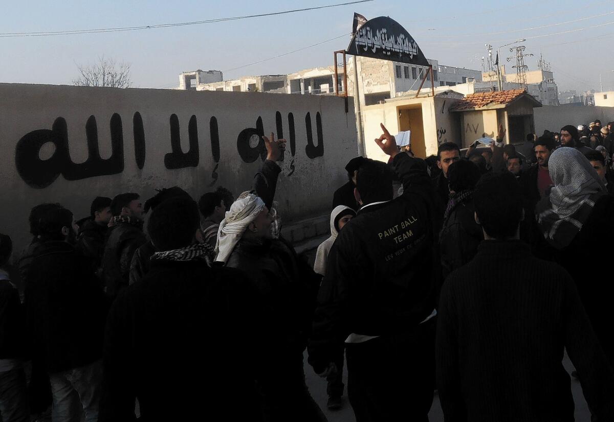 People gather outside the offices of the Islamic State of Iraq and Syria in the city of Aleppo to demand an end to fighting among rebel groups.