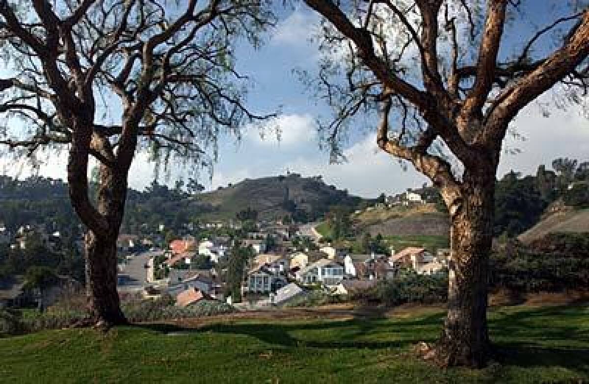 Homes north of Carbon Canyon Road in Chino Hills, a city of 73,000, are set against a hill and surrounded by parklands. Planners have clustered housing in villages throughout the 46-square-mile city to conserve undeveloped spaces.