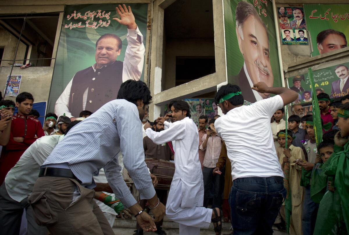 Supporters of former Pakistani Prime Minister Nawaz Sharif celebrate his election victory in Islamabad, Pakistan.