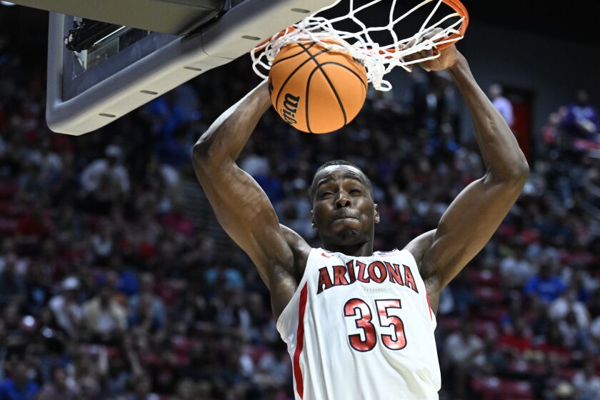 Arizona center Christian Koloko (35) dunks against Wright State during the second half of a first-round NCAA college basketball tournament game, Friday, March 18, 2022, in San Diego. (AP Photo/Denis Poroy)