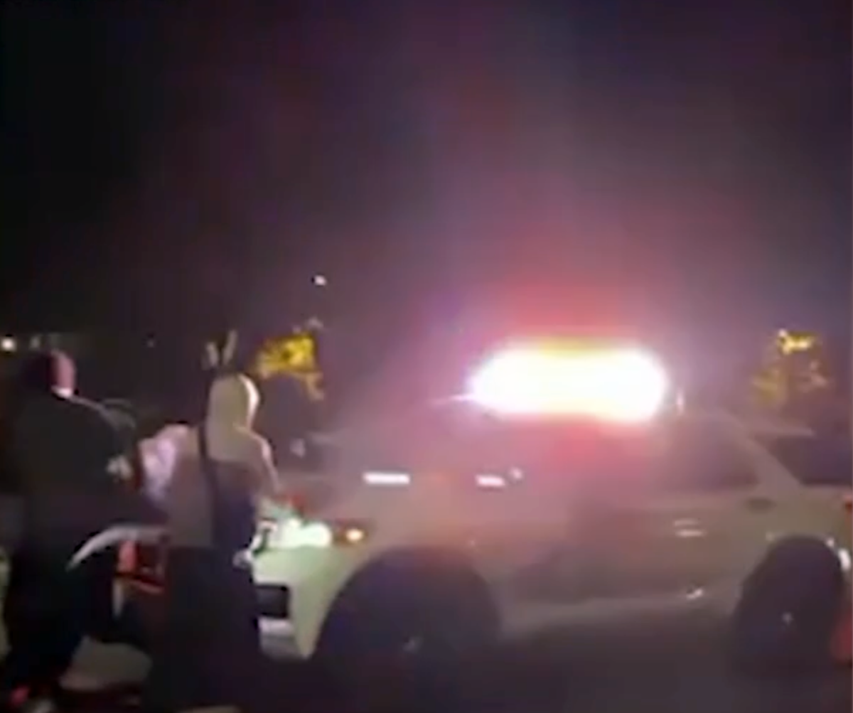 A mob attacks a San Bernardino County Sheriff’s Department patrol car.