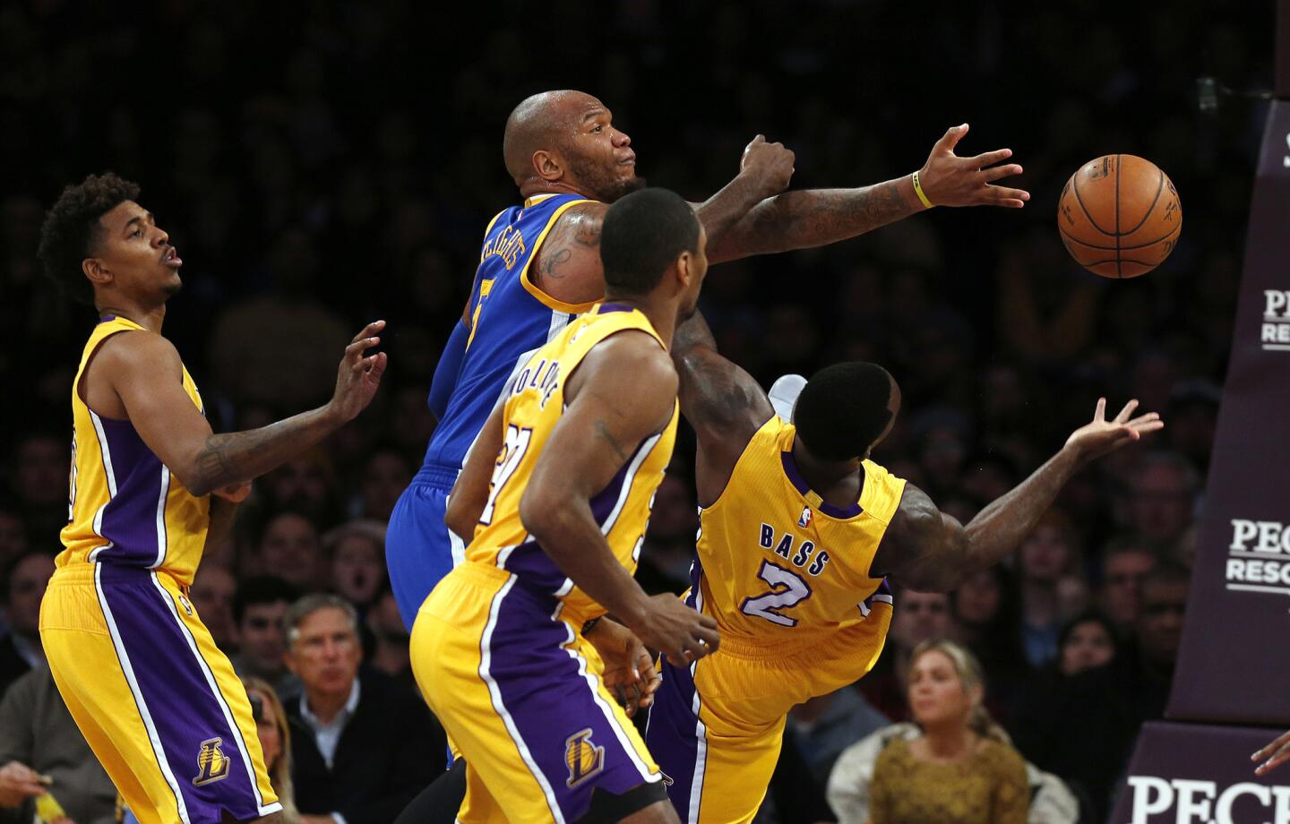 Marreese Speights (5) of the Warriors battles with a crowd of Lakers for a rebound during the first half of a game at Staples Center on Jan. 5.