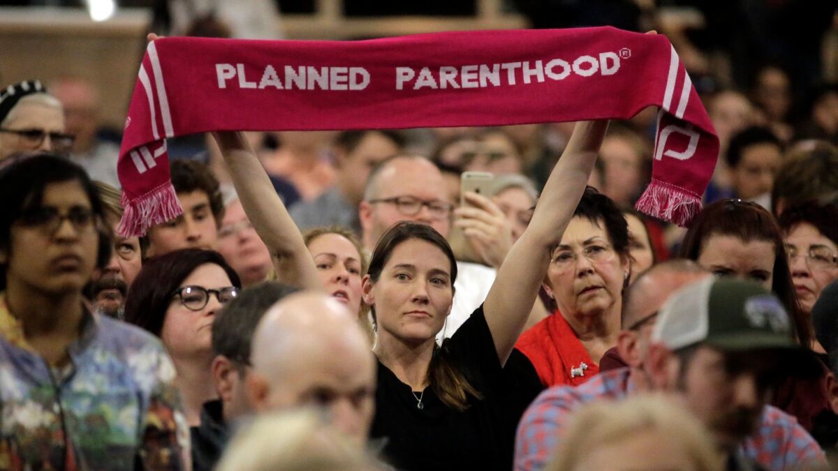 A Planned Parenthood supporter looks on during Rep. Jason Chaffetz's town hall meeting on Feb. 9, in Cottonwood Heights, Utah.