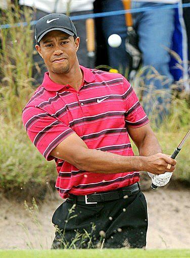 Tiger Woods chips out of the bunker.