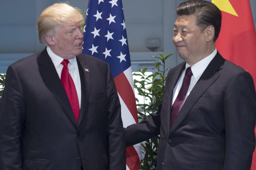 President Trump, left, and Chinese President Xi Jinping arrive for a meeting on the sidelines of the G-20 Summit in Hamburg, Germany on Saturday, July 8, 2017.