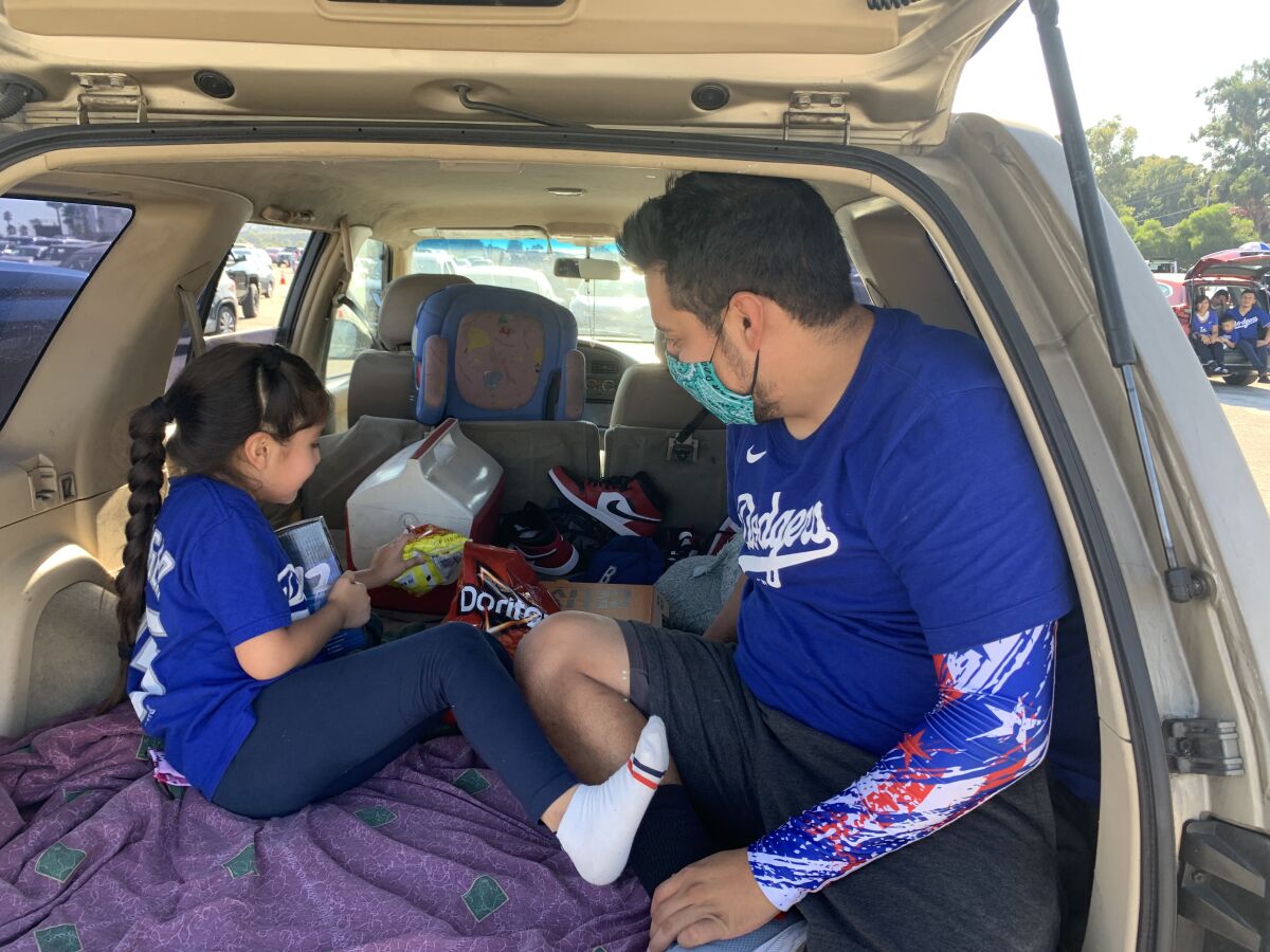 Erik Garcia brought little sister Melissa to the Dodgers’ drive-in watch party of Game 2 of the NLCS.