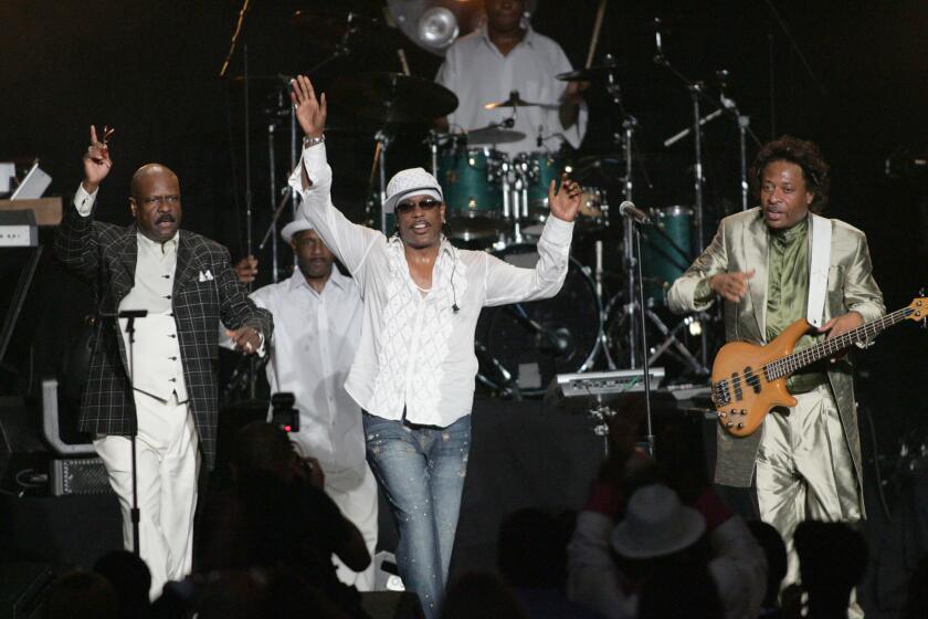 FILE - Members of The GAP Band, brothers Ronnie Wilson, from left, Charlie and Robert acknowledge the crowd after performing at the 2005 BMI Urban Music Awards in Miami Beach, Fla., on Aug. 26, 2005. Ronnie Wilson, multi-instrumentalist and founder of the funk group, has died. He was 73. His wife posted on Facebook that her husband died on Tuesday, Nov. 2, 2021. (AP Photo/Luis M. Alvarez, File)