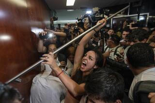 Protesters attempt to break into a room in the Senate as lawmakers weigh the government's proposed judicial reform, which would make judges stand for election, in Mexico City, Tuesday, Sept. 10, 2024. (AP Photo/Felix Marquez)