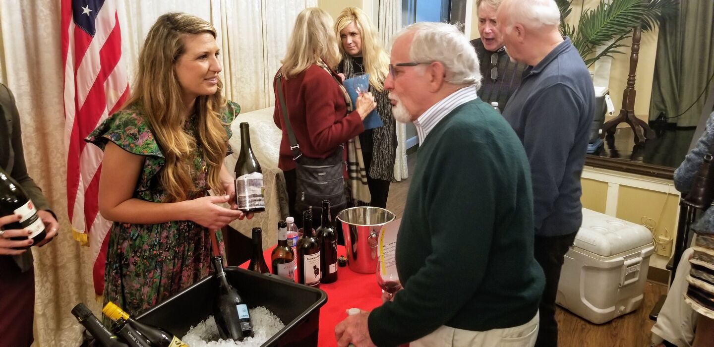 Kelly Bruckart offers samples from Wine Warehouse.