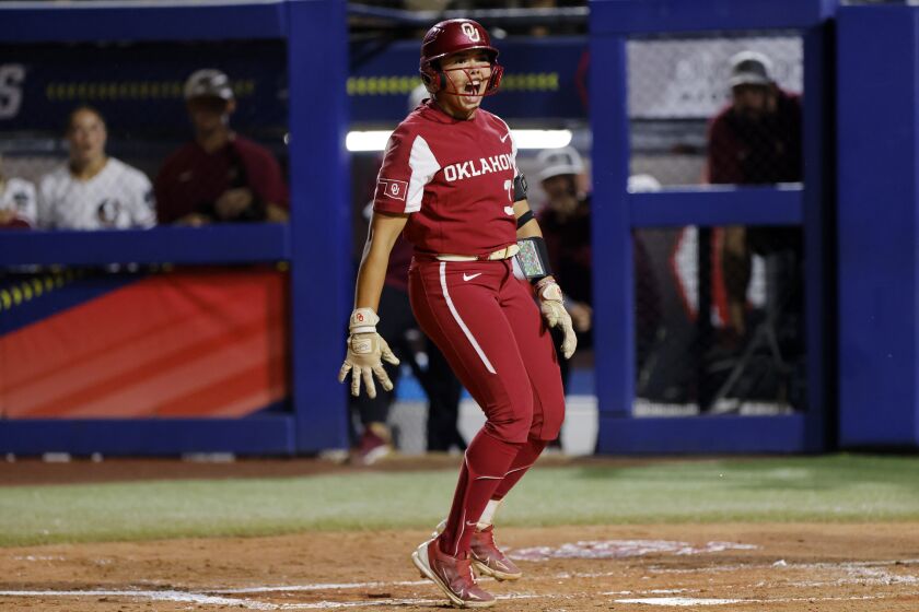 Oklahoma's Alyssa Brito celebrates after drawing a walk from Florida State during the second inning of the first game of the NCAA Women's College World Series softball championship series Wednesday, June 7, 2023, in Oklahoma City. (AP Photo/Nate Billings)
