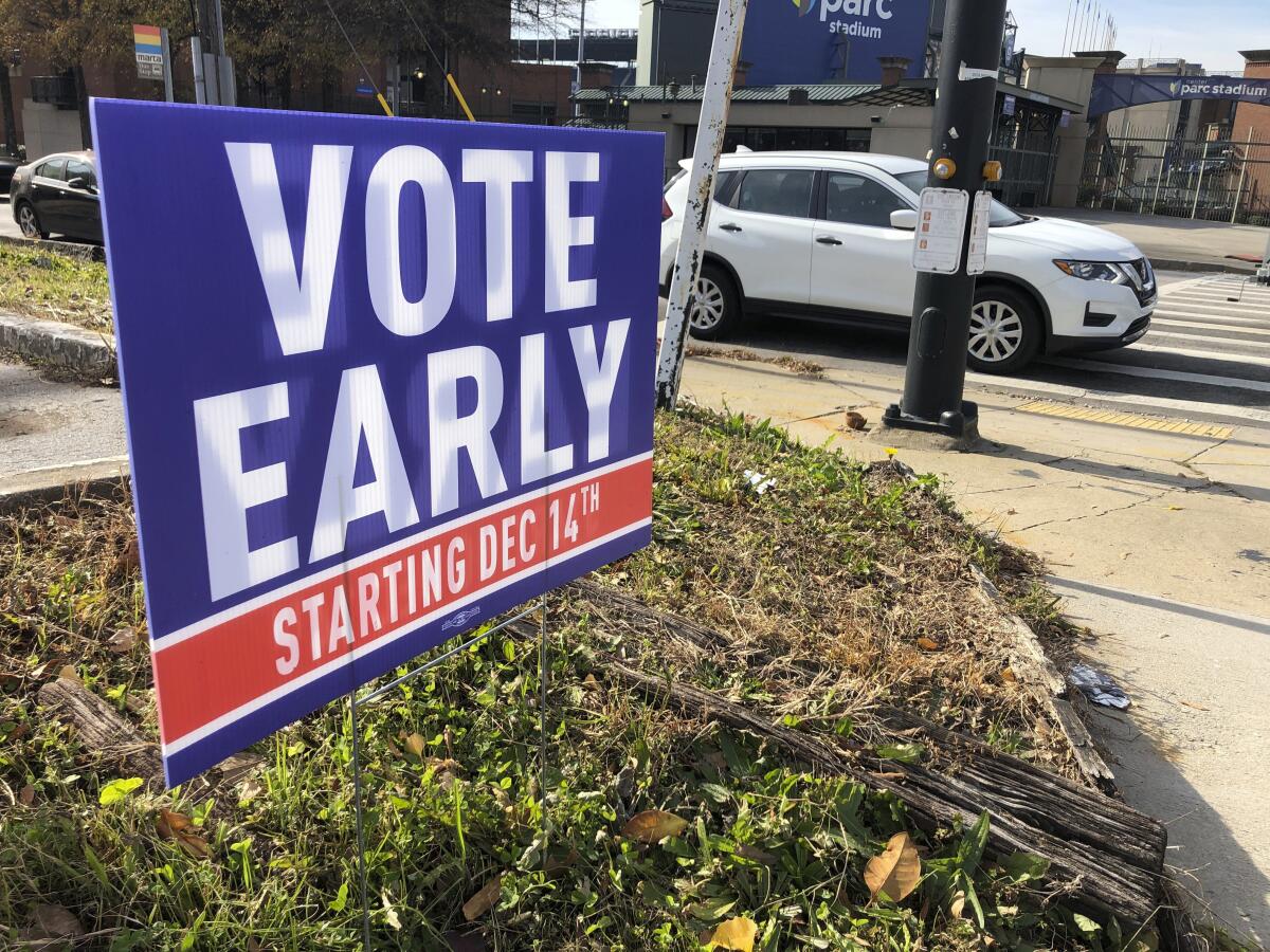 A sign in an Atlanta yard urges neighbors to vote early.