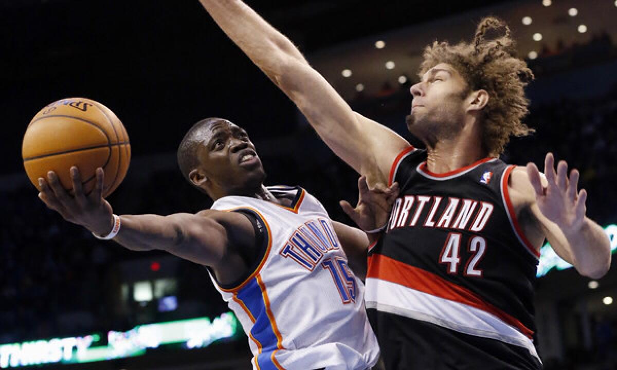 Oklahoma City Thunder guard Reggie Jackson, left, puts up a shot in front of Portland Trail Blazers center Robin Lopez during a game on Jan. 21. The two teams meet again Tuesday in a Western Conference showdown.