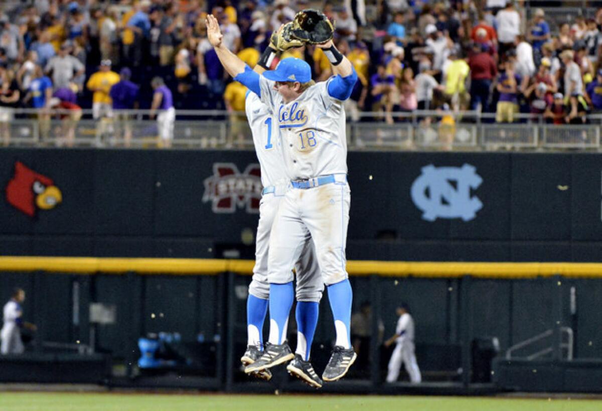 UCLA's Pat Valaika, left, and Cody Regis celebrate after the last out against LSU.