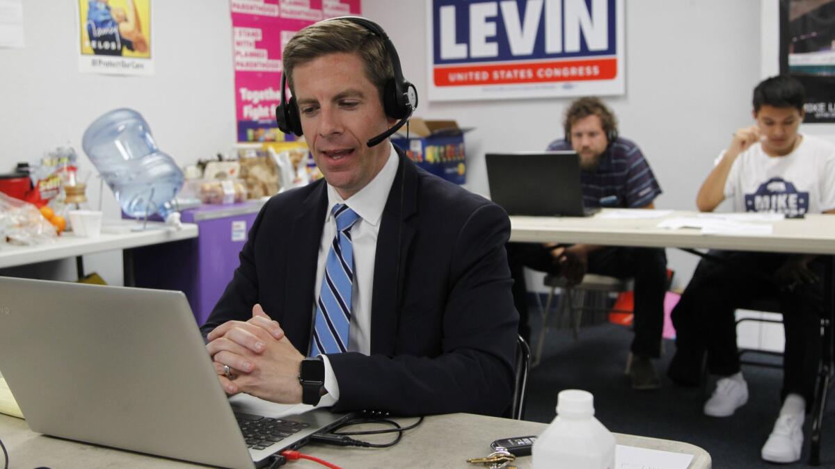 Democrat Mike Levin, congressional candidate for the 49th District, calls voters in Vista in June.