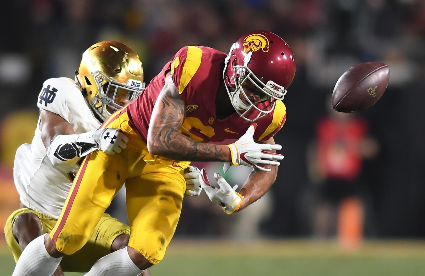 USC receiver Michael Pittman fumbles the ball as Notre Dame's Troy Price makes the tackle in the first quarter at the Coliseum Saturday. Notre Dame recovered the ball.