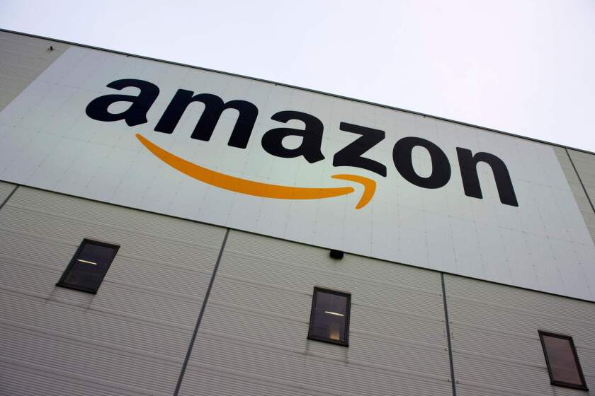 (FILES) In this file photo taken on November 11, 2014 (FILES) In this file photo taken on November 11, 2014 the logo of US online retail giant Amazon is displayed on the Brieselang logistics center, west of Berlin. - Amazon for the first time closed out Monday's, January 7, 2019, session as the world's biggest company by market capitalization, overtaking Microsoft and other fellow tech behemoths. The online sales goliath assumed the top spot after notching a 3.4 percent gain to finish with a market capitalization of $796.8 billion, about $13.2 billion more than Microsoft. (Photo by John MACDOUGALL / AFP)JOHN MACDOUGALL/AFP/Getty Images ** OUTS - ELSENT, FPG, CM - OUTS * NM, PH, VA if sourced by CT, LA or MoD **