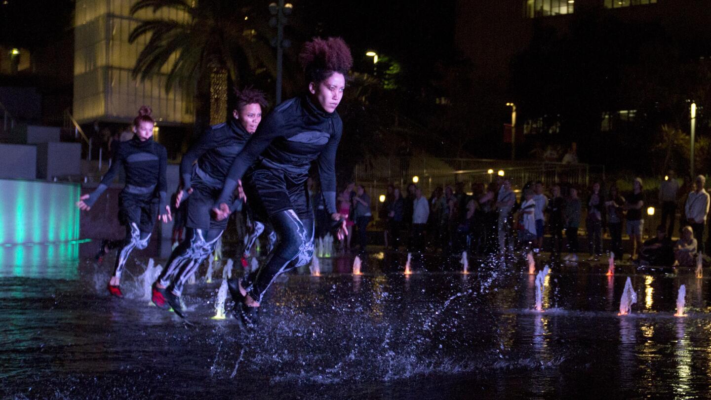 Dancers from Decadancetheatre perform "The Firebird" in the fountain in Grand Park on Monday, the Music Center’s opening night of its contemporary dance program Moves After Dark.