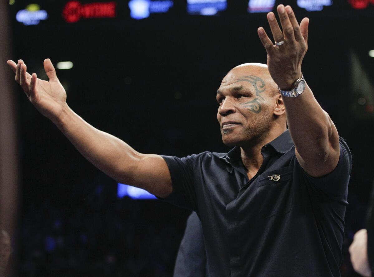 Former boxer Mike Tyson acknowledges the crowd before a WBC heavyweight title boxing match between Deontay Wilder and Artur Szpilka in New York on Jan. 16.