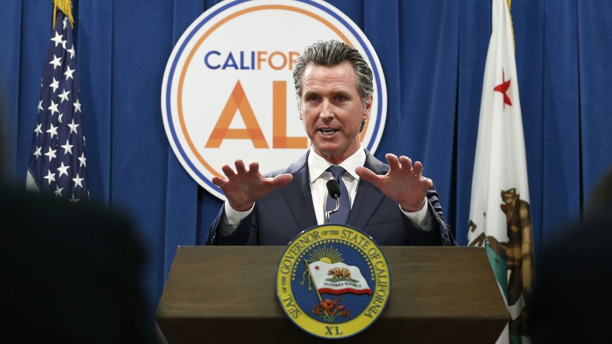 Gov. Gavin Newsom discusses his revised 2019-20 state budget during a news conference Thursday in Sacramento.