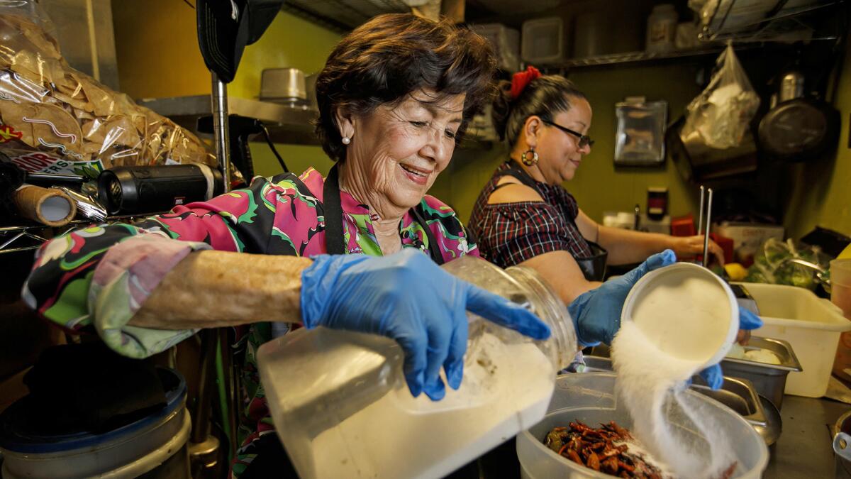 Elena Castros help prepare food in the kitchen at Teddy's Tacos in City of Industry.