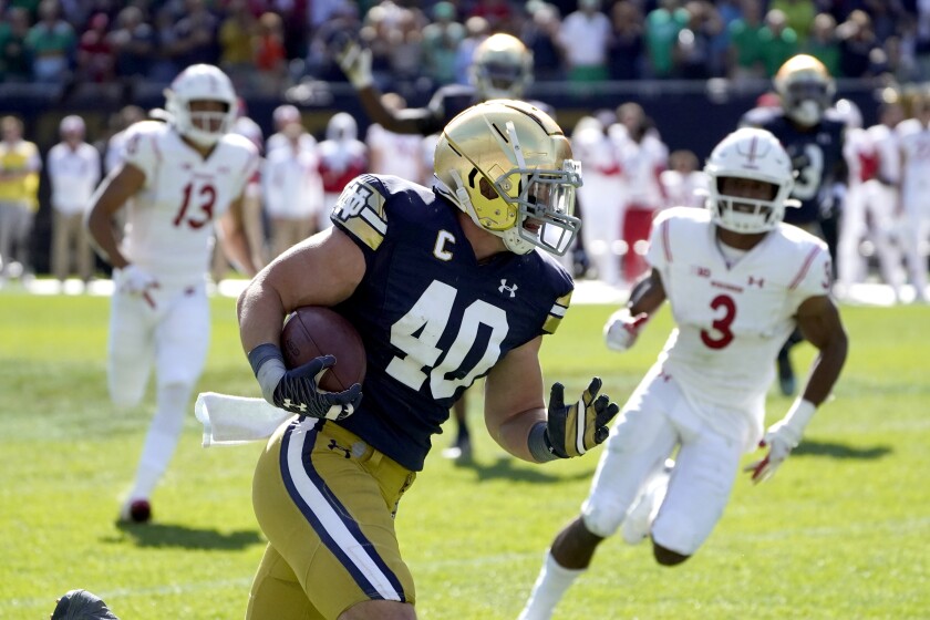 Notre Dame linebacker Drew White returns an interception for a touchdown against Wisconsin on Sept. 25, 2021.