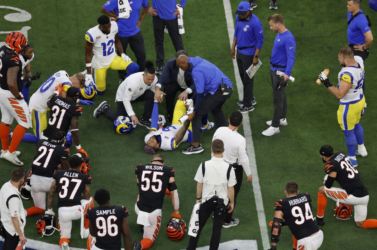 Rams wide receiver Odell Beckham Jr. is attended to by trainers after sustaining a knee injury.