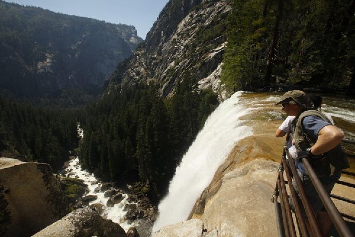 Yosemite National Park visitors look over Vernal Fall .