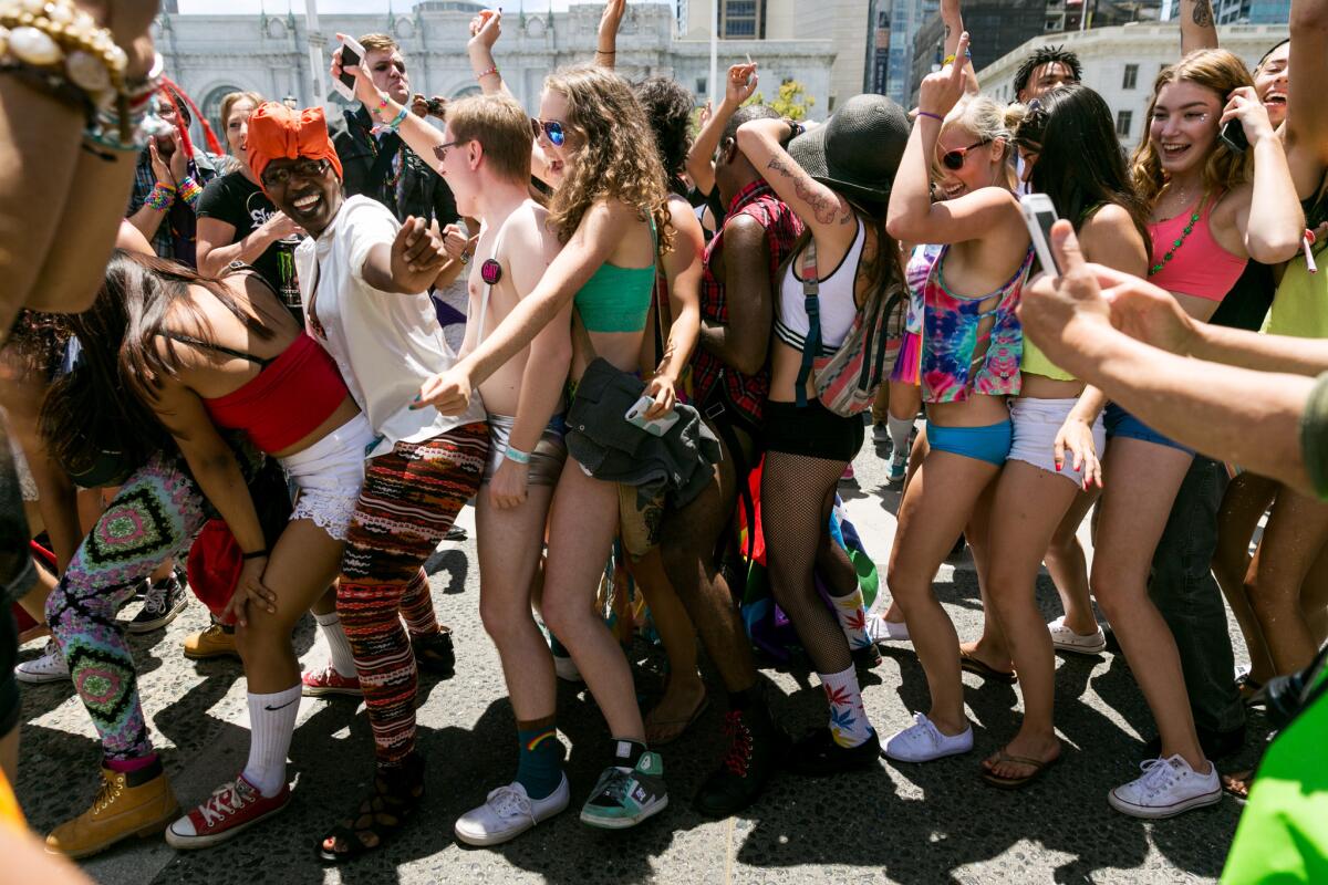 Revelers dance during Pride Week festivities at the Civic Center in San Francisco on Saturday. Shots were fired Saturday night amid a crowd celebrating Pride Week, but police said the shooting was unrelated to the Pride events.
