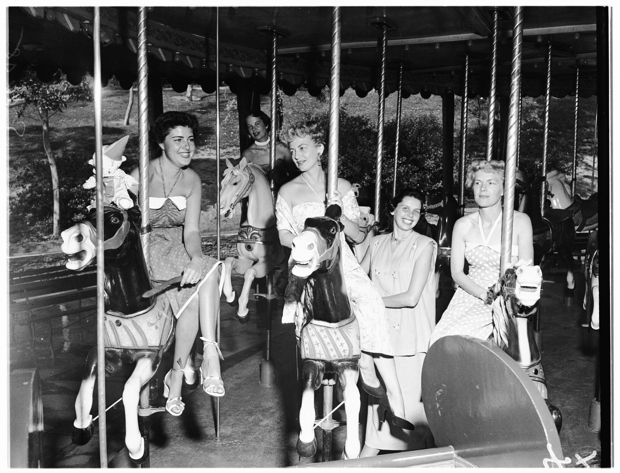 A achromatic and achromatic photograph of patrons connected the Griffith Park merry-go-round.