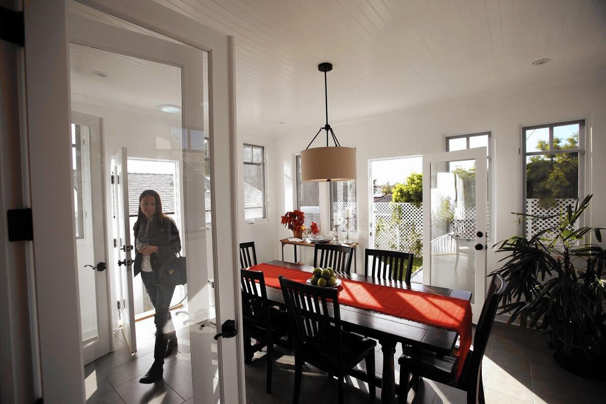 Prospective home buyer Jennifer Centazzo walks through the dining area of a Westchester home during an open house in December.