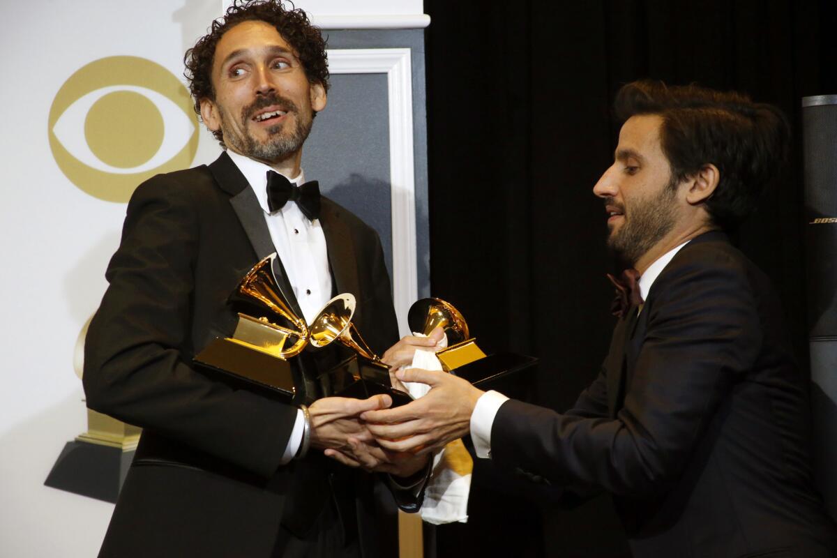 John Daversa arrives in the press room with his three Grammy Awards on Sunday.
