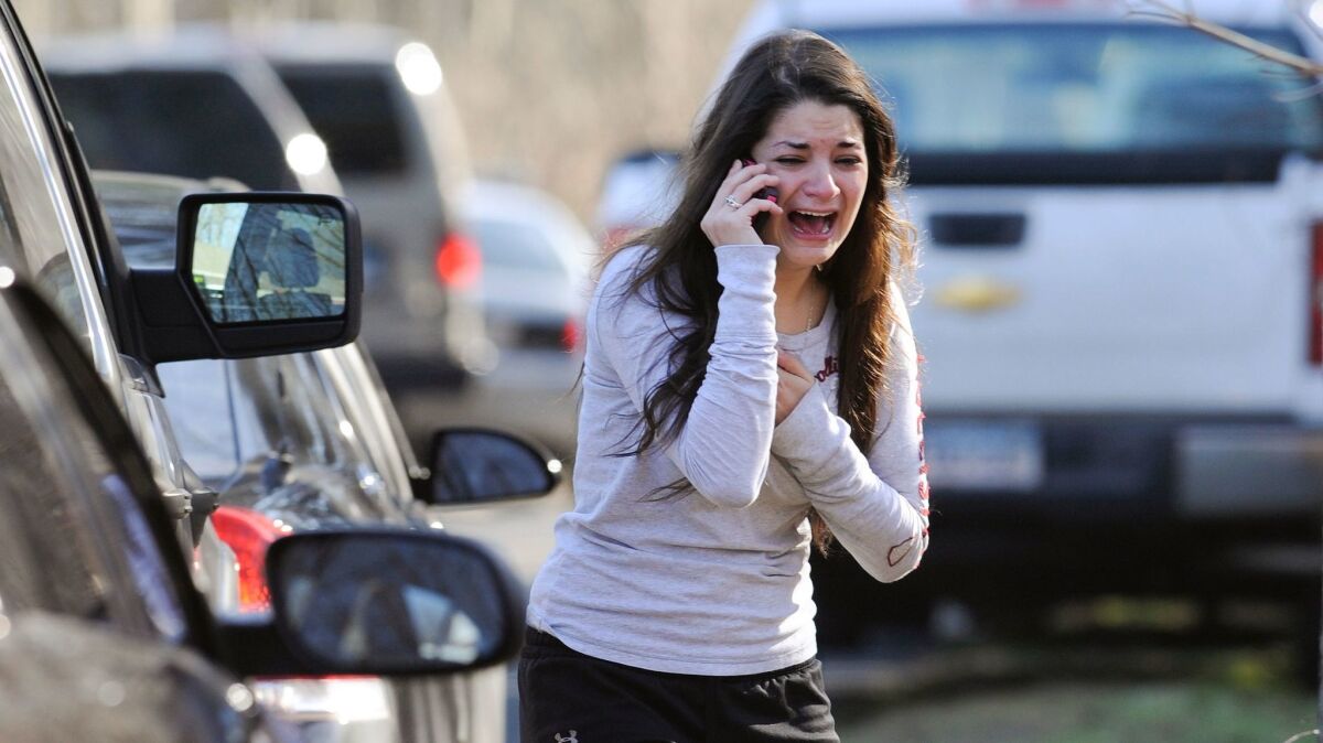 A woman waits to hear about her sister, a teacher, following the shooting at Sandy Hook Elementary School in Newtown, Conn. on Dec. 14, 2012.