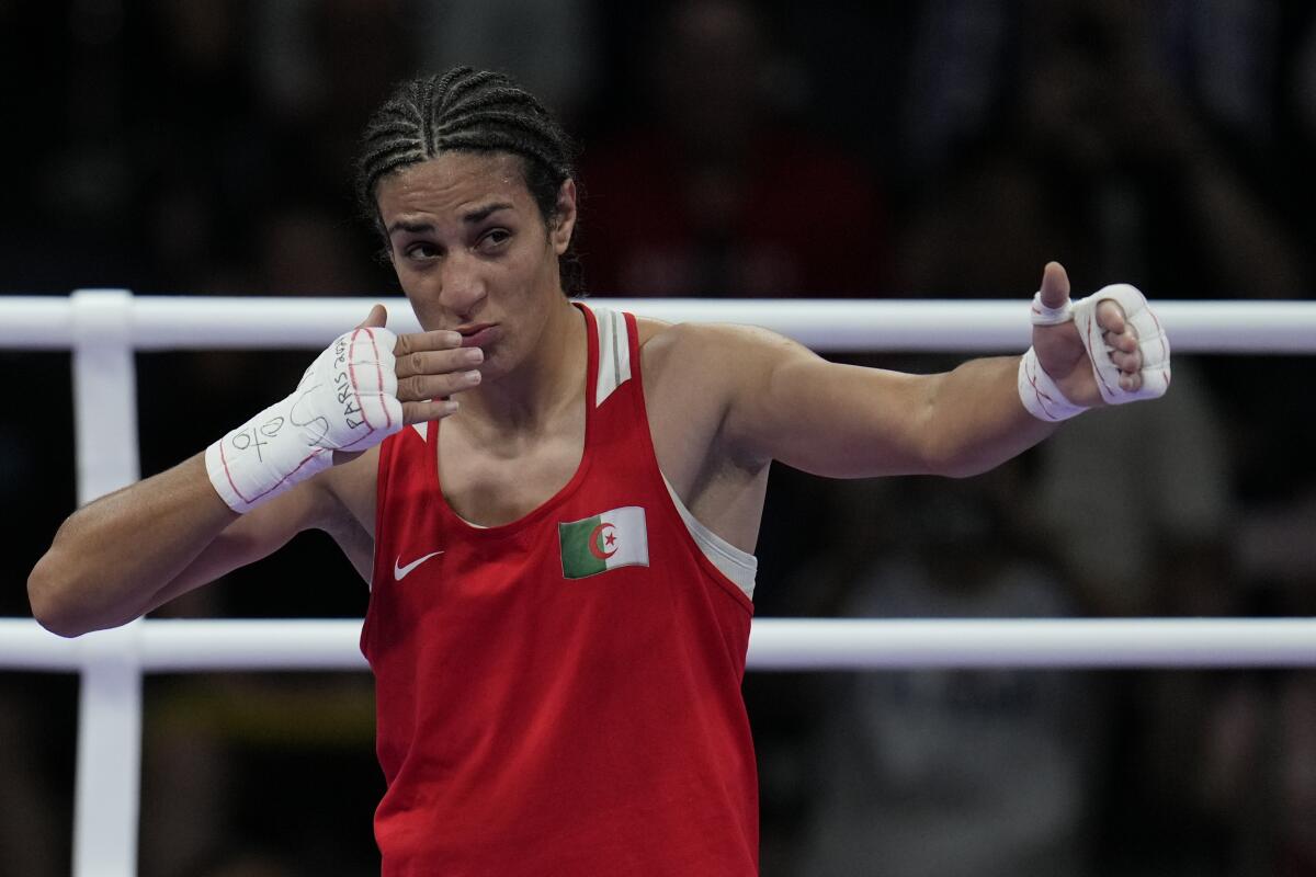 Algeria's Imane Khelif celebrates after winning her quarterfinal boxing match.
