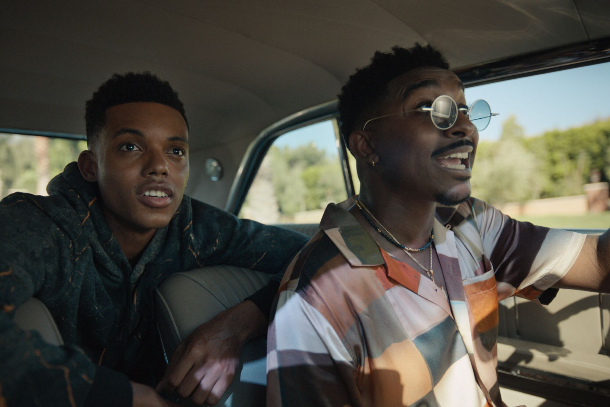 Two men ride in a car.