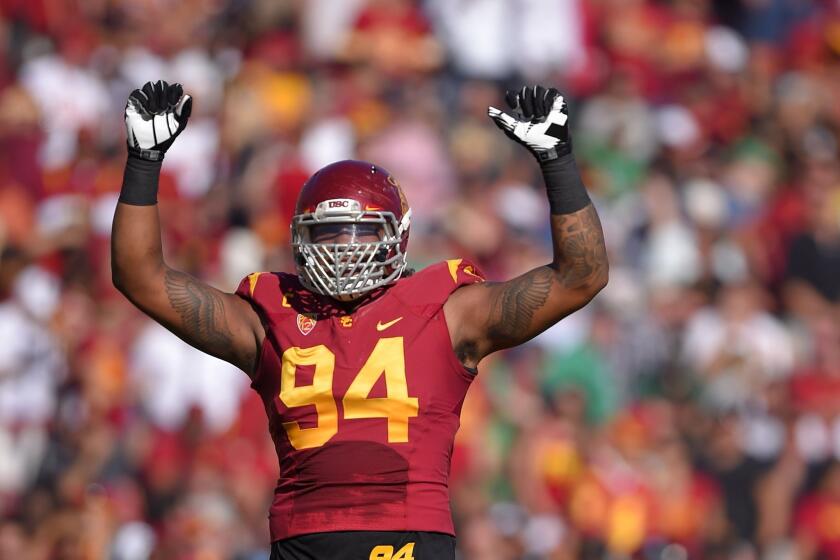 USC defensive end Leonard Williams gestures to fans during the Trojans' 49-14 victory over Notre Dame.