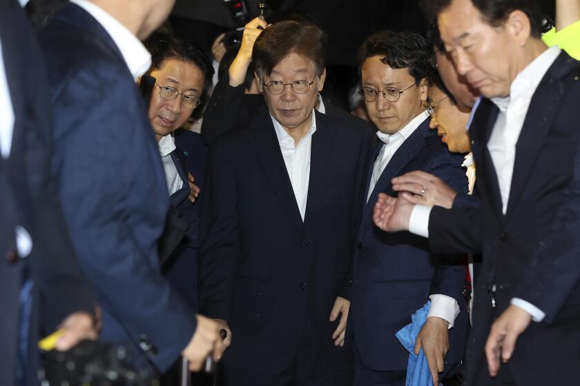 South Korea's main opposition Democratic Party leader Lee Jae-myung, center, walks out of a detention center in Uiwang, South Korea, Wednesday, Sept. 27, 2023. A South Korean judge on Wednesday denied an arrest warrant for the country's opposition leader on broad corruption allegations, saying there wasn't a clear risk that he would destroy evidence. (Han Jong-chan/Yonhap via AP)