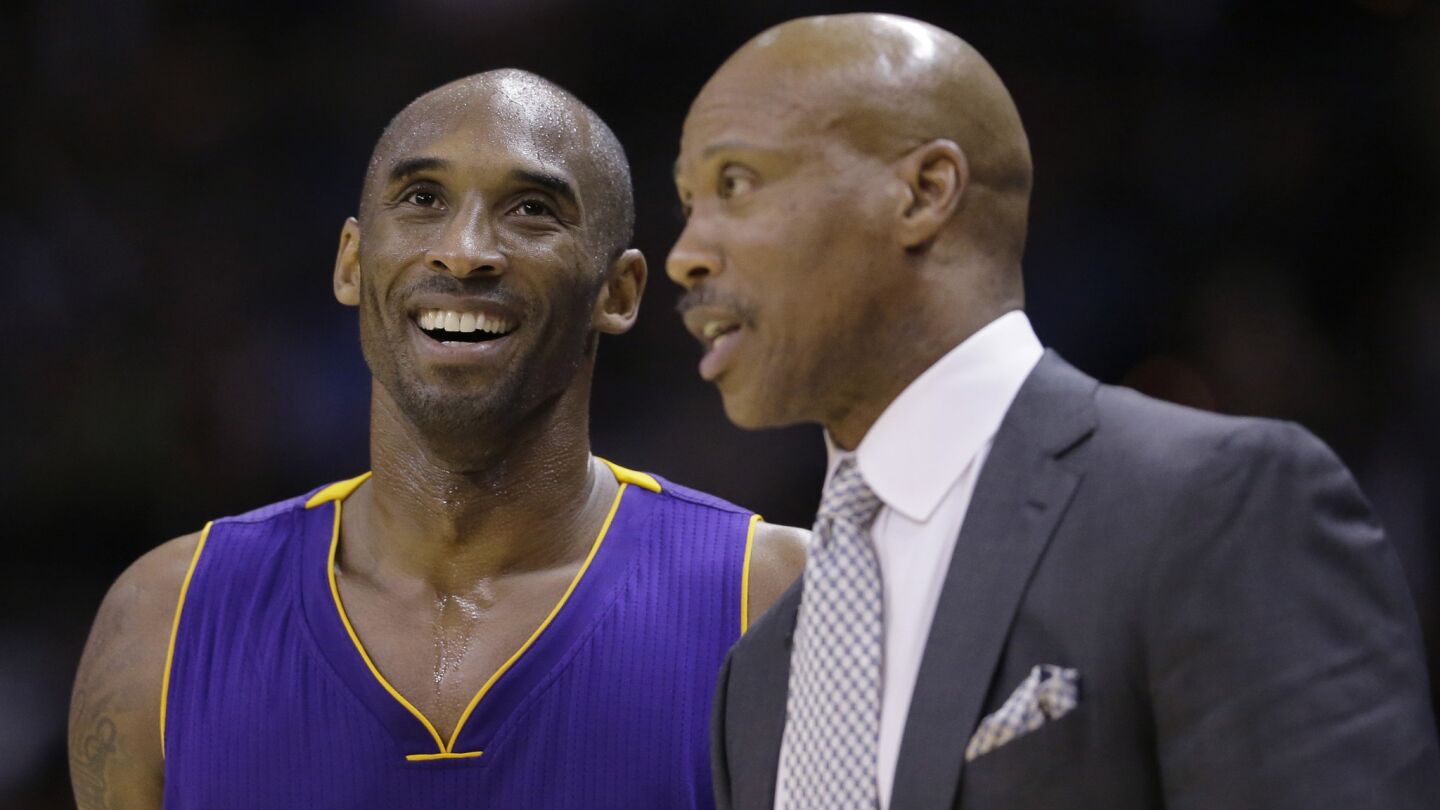 Lakers star Kobe Bryant, left, speaks with Coach Byron Scott during a game against the San Antonio Spurs last December.