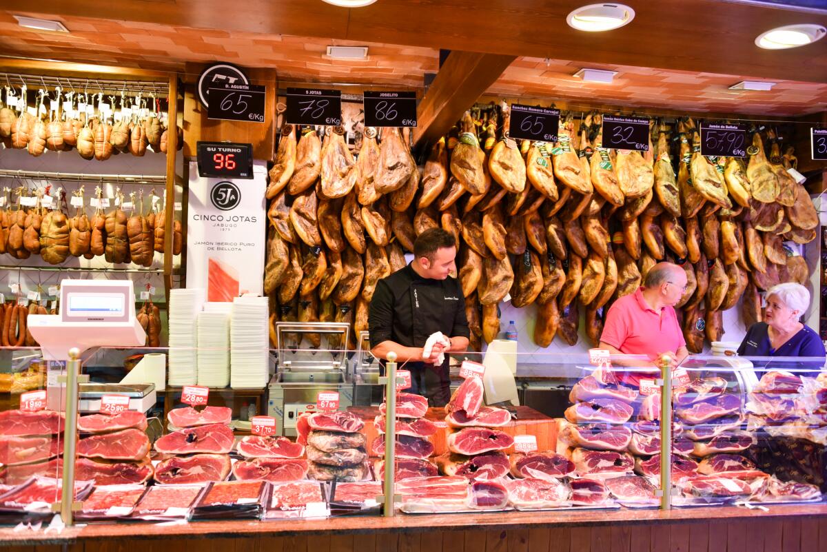 Different kinds of meat are displayed at the market hall of Palma de Mallorca.