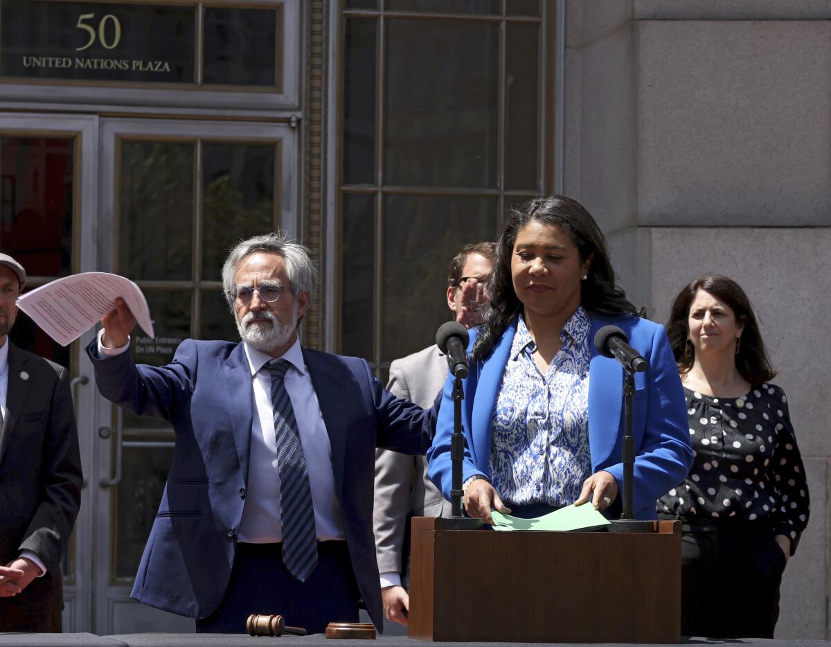 San Francisco Mayor London Breed steps up to the podium to speak in San Francisco.
