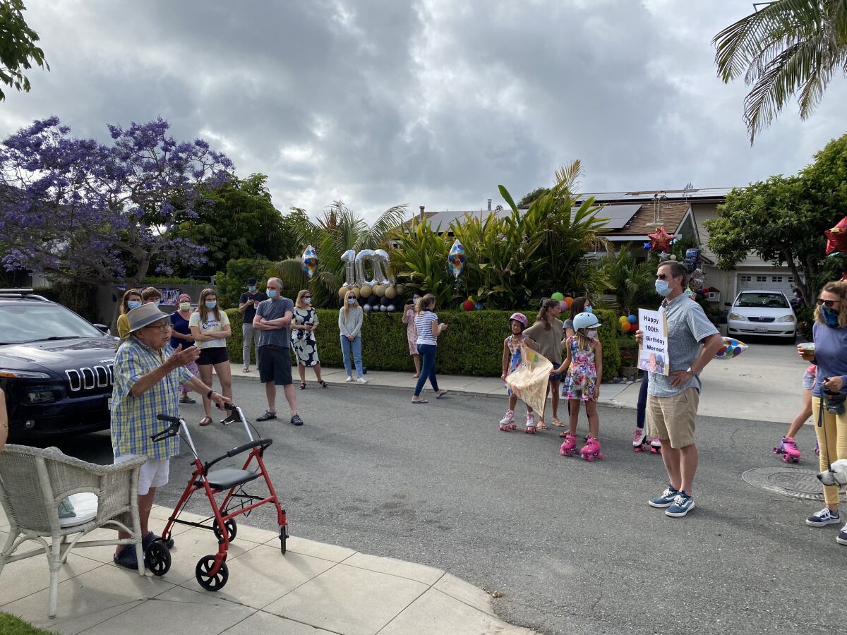 People gather to sing "Happy Birthday" to 100-year-old Werner Cahn in his La Jolla neighborhood.