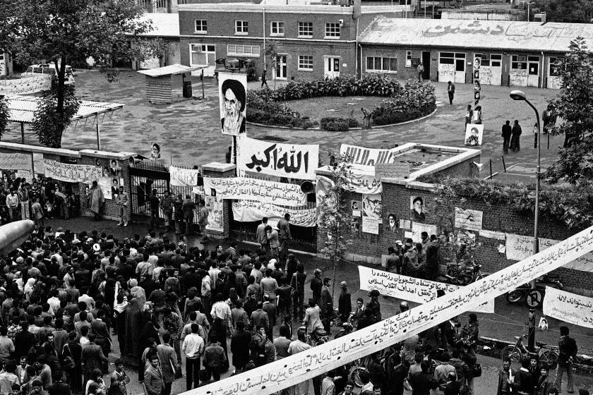 FILE - In this Nov. 6, 1979 file photo, Iranians gather before the entrance of the U.S. Embassy compound in Tehran, Iran. Nov. 4, 2019, will mark the 40th anniversary of the start of the 444-day hostage crisis that soured relations between the U.S. and the Islamic Republic for decades to come. (AP Photo, File)